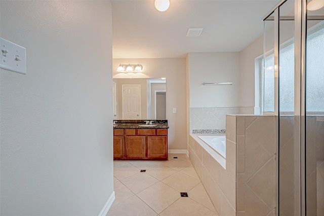 full bath with tile patterned flooring, a garden tub, vanity, visible vents, and baseboards