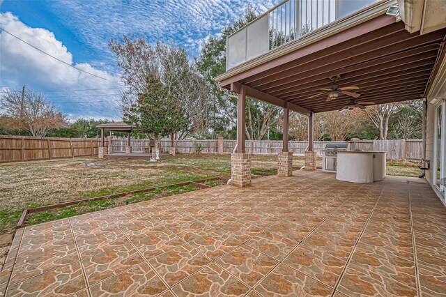 view of patio with area for grilling, a gazebo, and ceiling fan