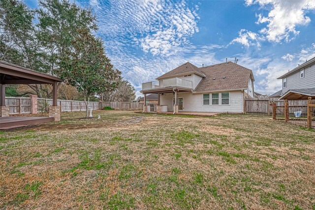 rear view of property with a lawn