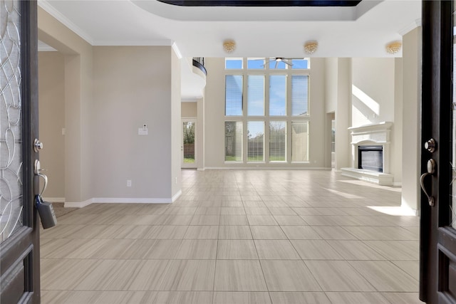 unfurnished living room with crown molding