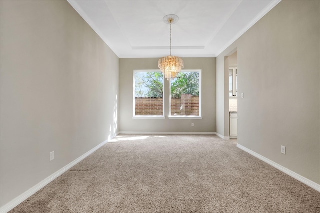 unfurnished dining area featuring a tray ceiling, a chandelier, and carpet