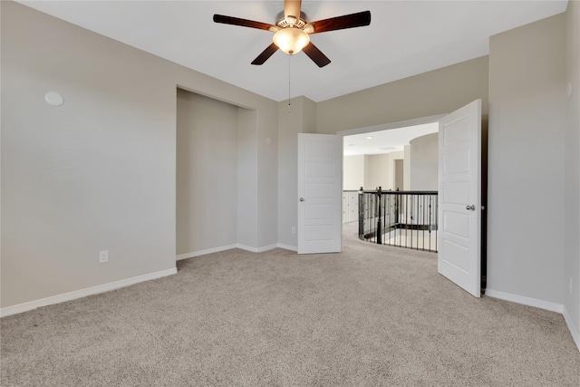 carpeted empty room featuring ceiling fan