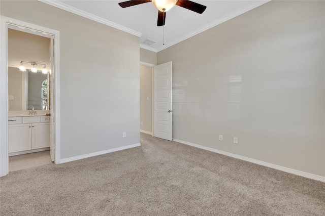 carpeted spare room with crown molding, ceiling fan, and sink