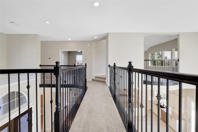 hallway featuring light carpet