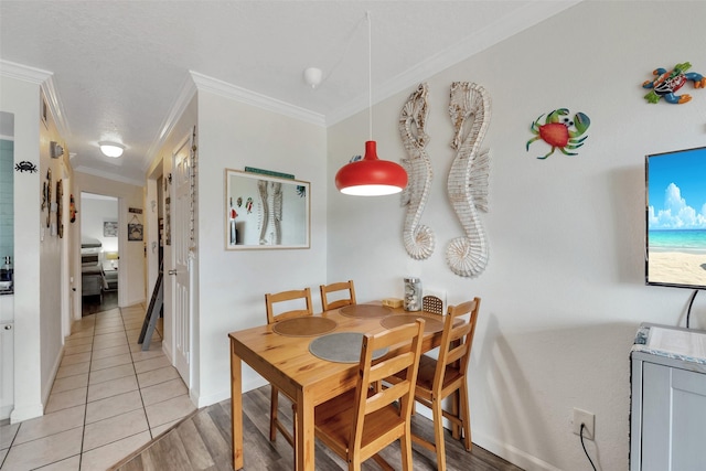 dining space featuring light tile patterned floors and ornamental molding