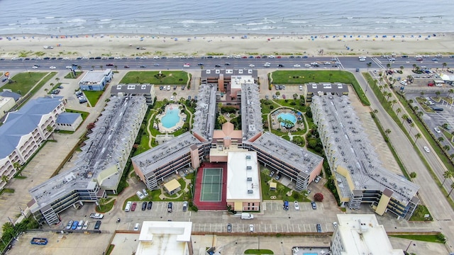 drone / aerial view featuring a beach view and a water view