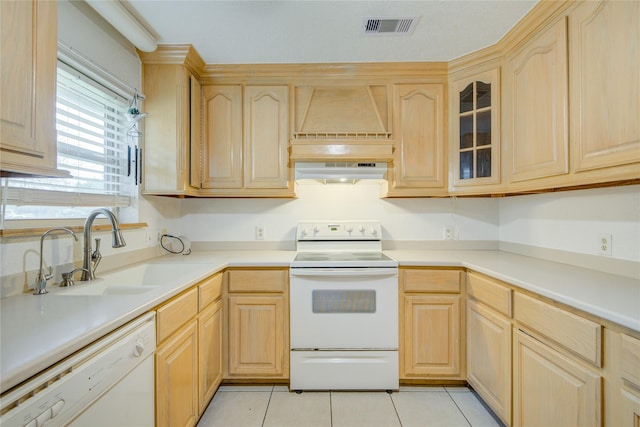 kitchen with white appliances, light brown cabinetry, sink, and light tile patterned floors