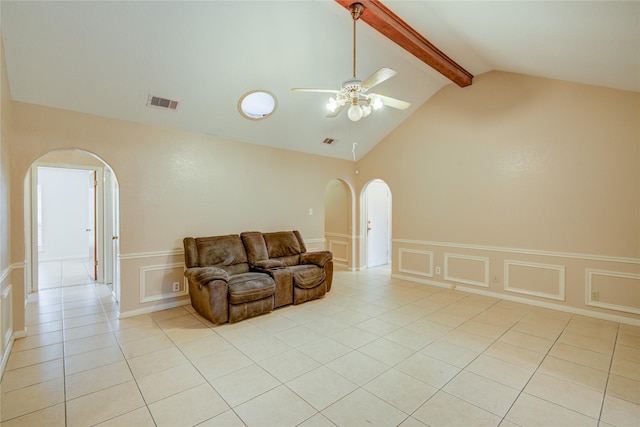 tiled living room featuring ceiling fan and vaulted ceiling with beams