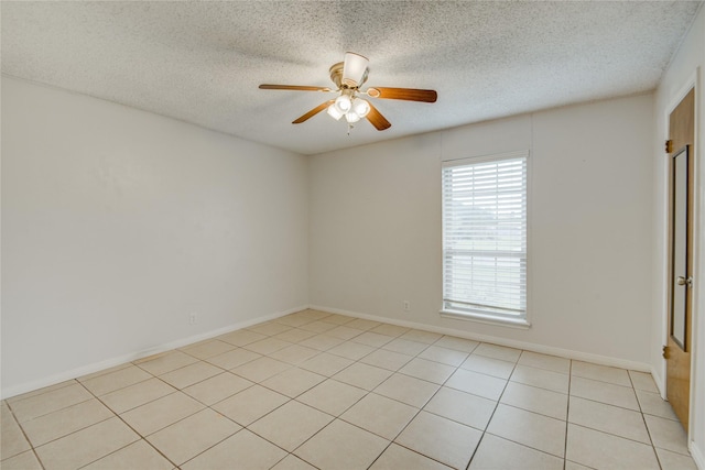 tiled spare room featuring ceiling fan and a textured ceiling