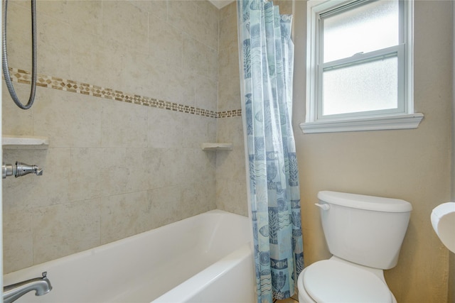 bathroom with toilet, shower / bath combo with shower curtain, and a wealth of natural light