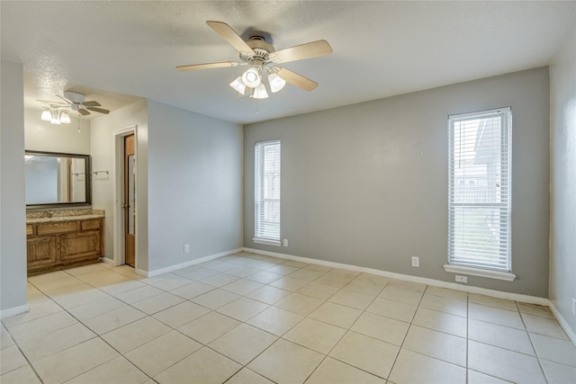 unfurnished room with light tile patterned floors and a healthy amount of sunlight