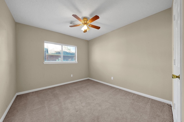 carpeted empty room with a textured ceiling and ceiling fan