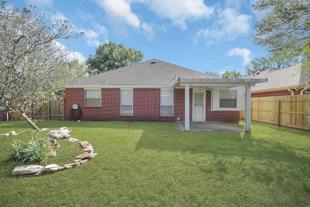 rear view of property featuring a yard and a patio