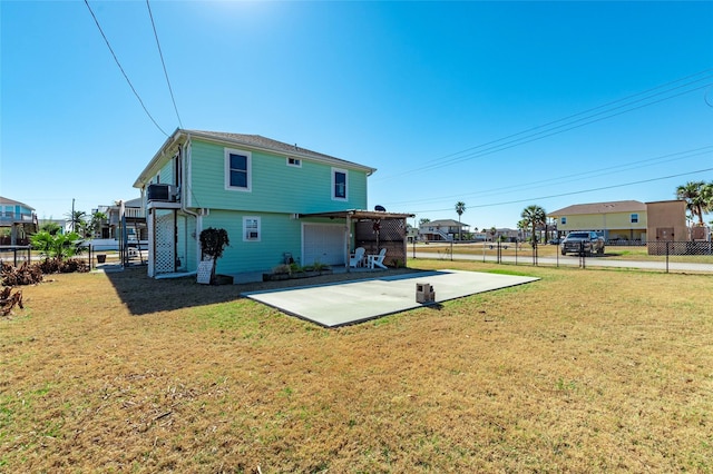 back of property featuring a patio, a yard, fence, and driveway