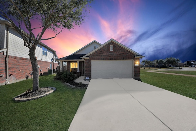 view of front of property with a garage, a lawn, and central air condition unit