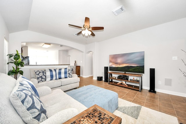 tiled living room featuring vaulted ceiling and ceiling fan