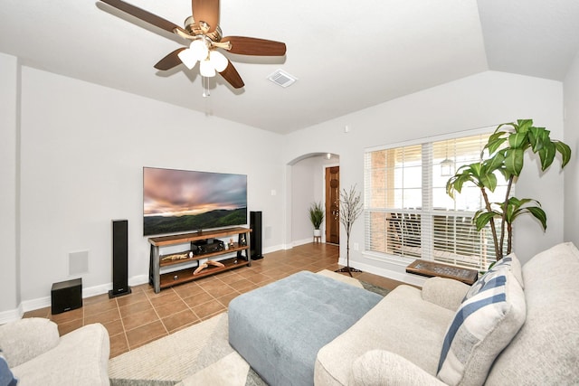 tiled living room with lofted ceiling and ceiling fan