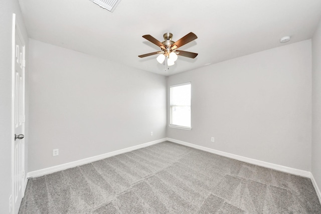 spare room with ceiling fan and carpet