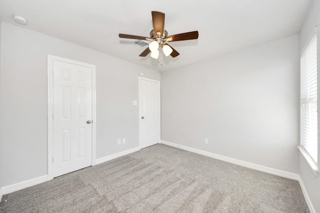 carpeted empty room featuring ceiling fan