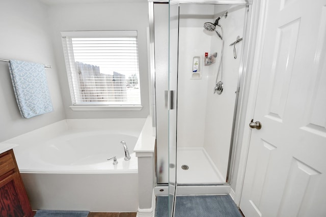 bathroom featuring vanity and independent shower and bath