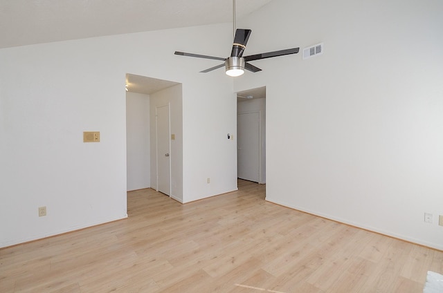 empty room with light hardwood / wood-style flooring, vaulted ceiling, and ceiling fan