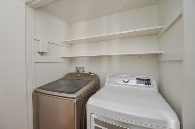 laundry area with washing machine and dryer