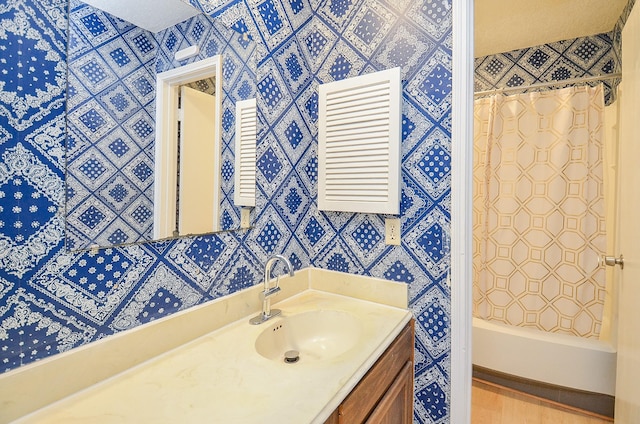 bathroom with walk in shower and vanity