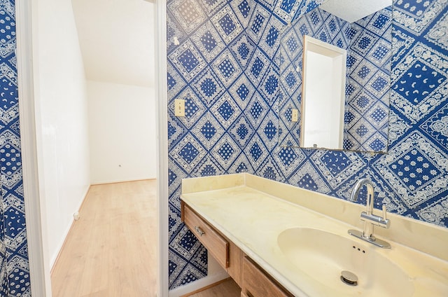 bathroom with hardwood / wood-style flooring and vanity