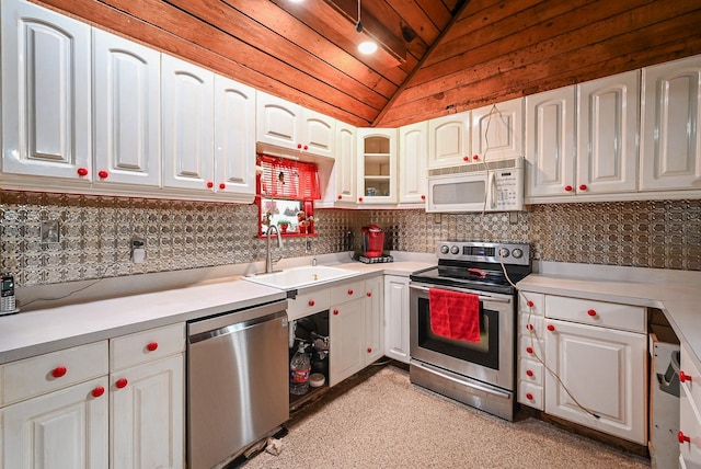 kitchen with lofted ceiling, sink, appliances with stainless steel finishes, white cabinetry, and wooden ceiling