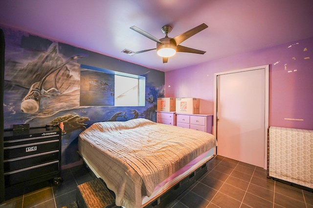 tiled bedroom featuring ceiling fan