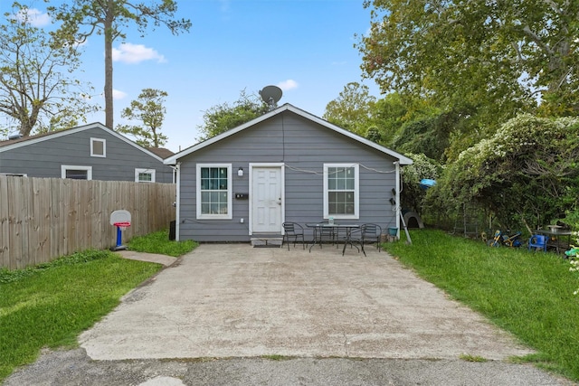 back of house featuring a yard and a patio area