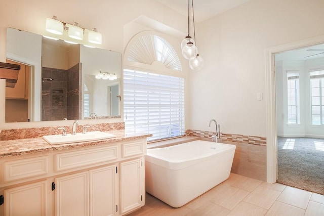 bathroom featuring plus walk in shower, tile walls, vanity, and tile patterned floors