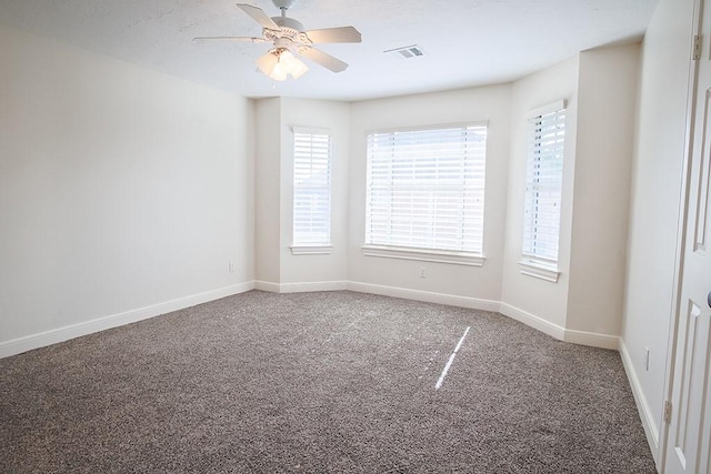 carpeted spare room featuring ceiling fan