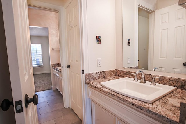 bathroom featuring tile patterned flooring and vanity