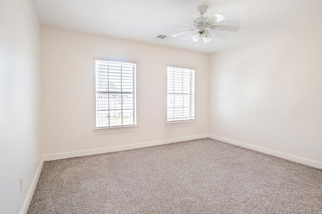 empty room with ceiling fan and carpet