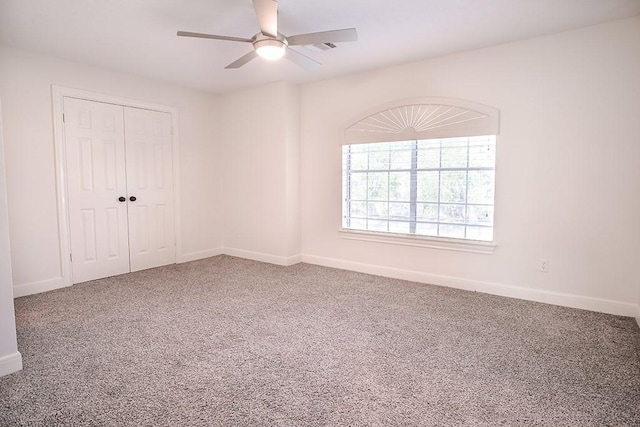 spare room featuring carpet floors and ceiling fan