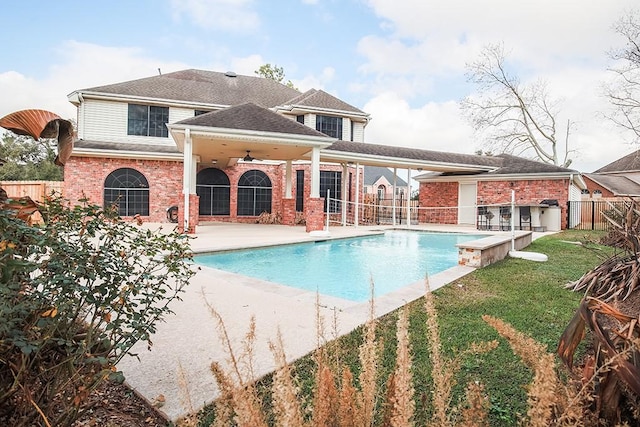 view of pool with a lawn, a patio, and ceiling fan