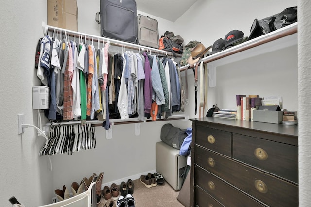 walk in closet with carpet flooring