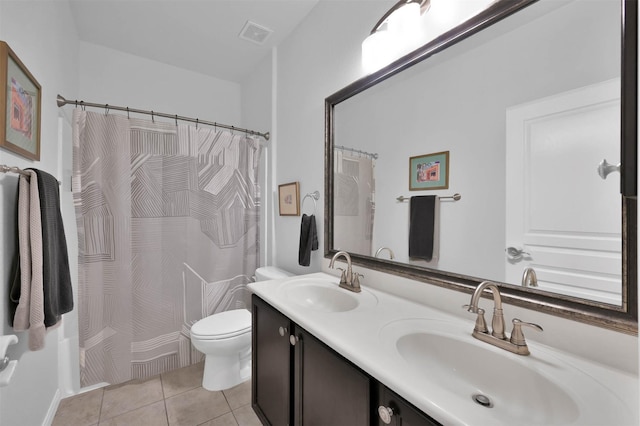 bathroom with vanity, tile patterned floors, and toilet