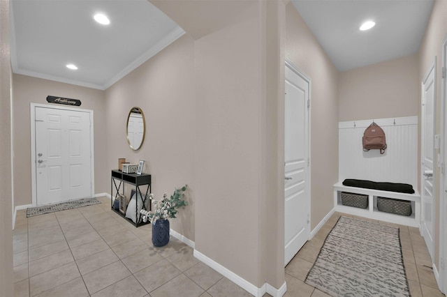 tiled entryway featuring ornamental molding