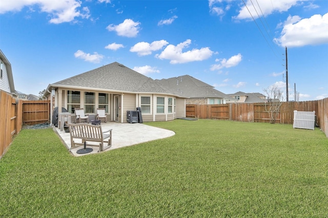 rear view of property with a patio area and a lawn