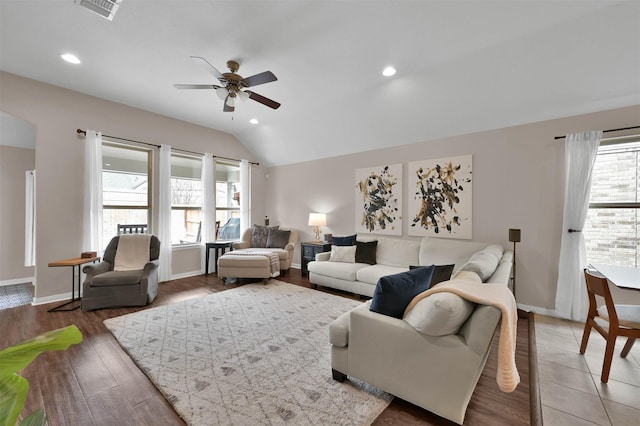 living room featuring lofted ceiling, hardwood / wood-style flooring, and ceiling fan