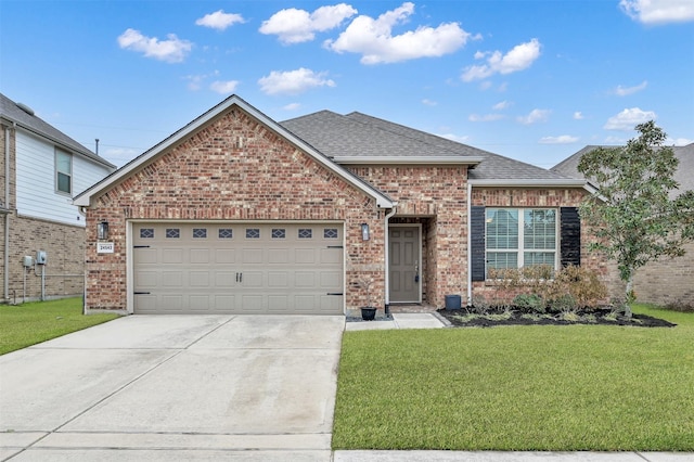 view of front of property featuring a garage and a front yard