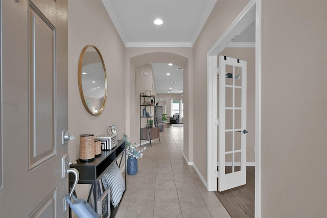 hallway featuring light tile patterned flooring and crown molding