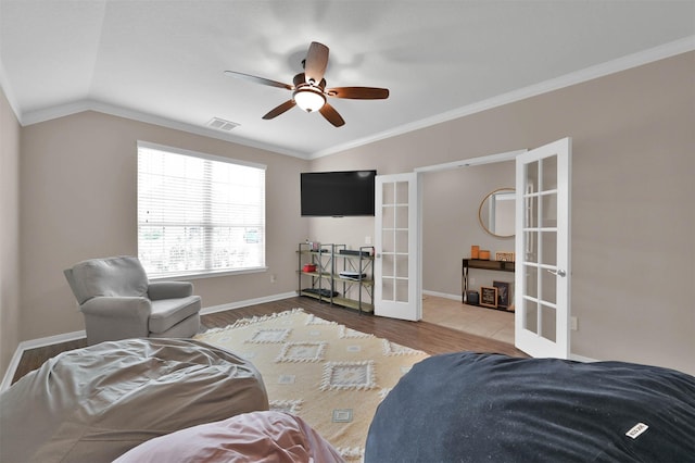 living room featuring french doors, vaulted ceiling, ornamental molding, hardwood / wood-style flooring, and ceiling fan