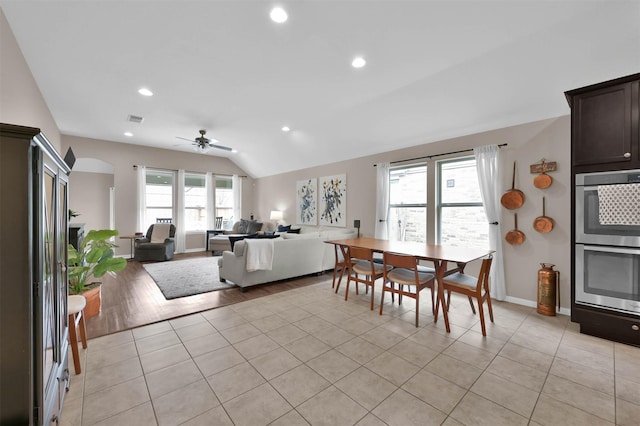 dining room with ceiling fan, vaulted ceiling, and light tile patterned floors