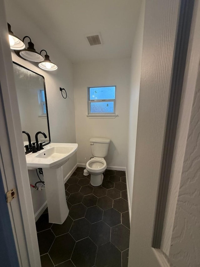 bathroom featuring tile patterned flooring and toilet