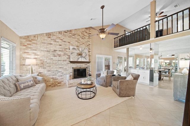 living room featuring light tile patterned flooring, brick wall, high vaulted ceiling, a fireplace, and ceiling fan