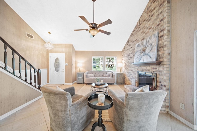 living room featuring light tile patterned floors, a fireplace, high vaulted ceiling, and ceiling fan