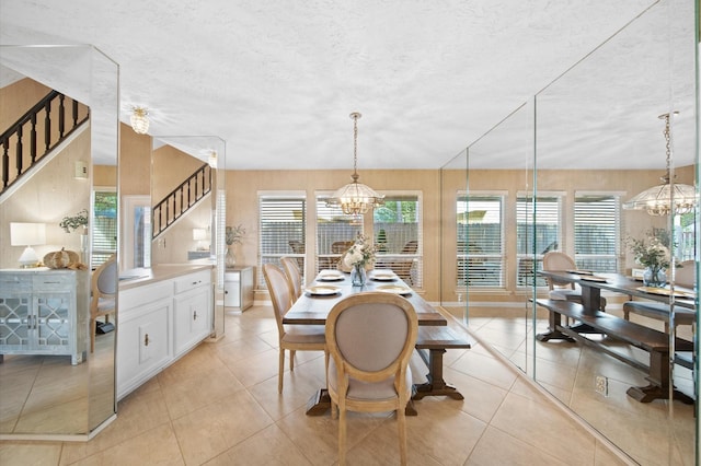 dining space with plenty of natural light, light tile patterned floors, and a notable chandelier